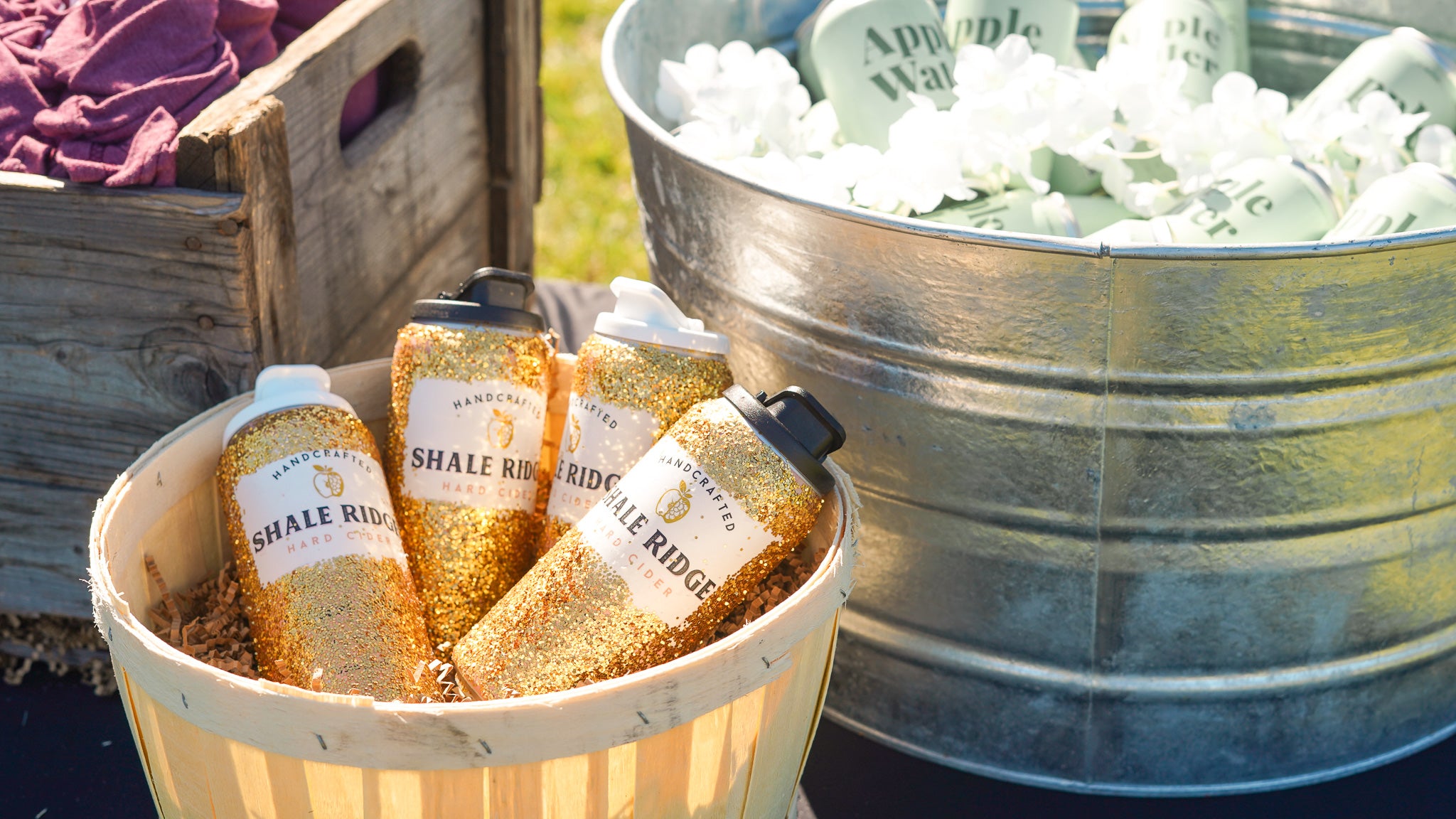 Baskets of golden Shale Ridge cans and Apple Water.