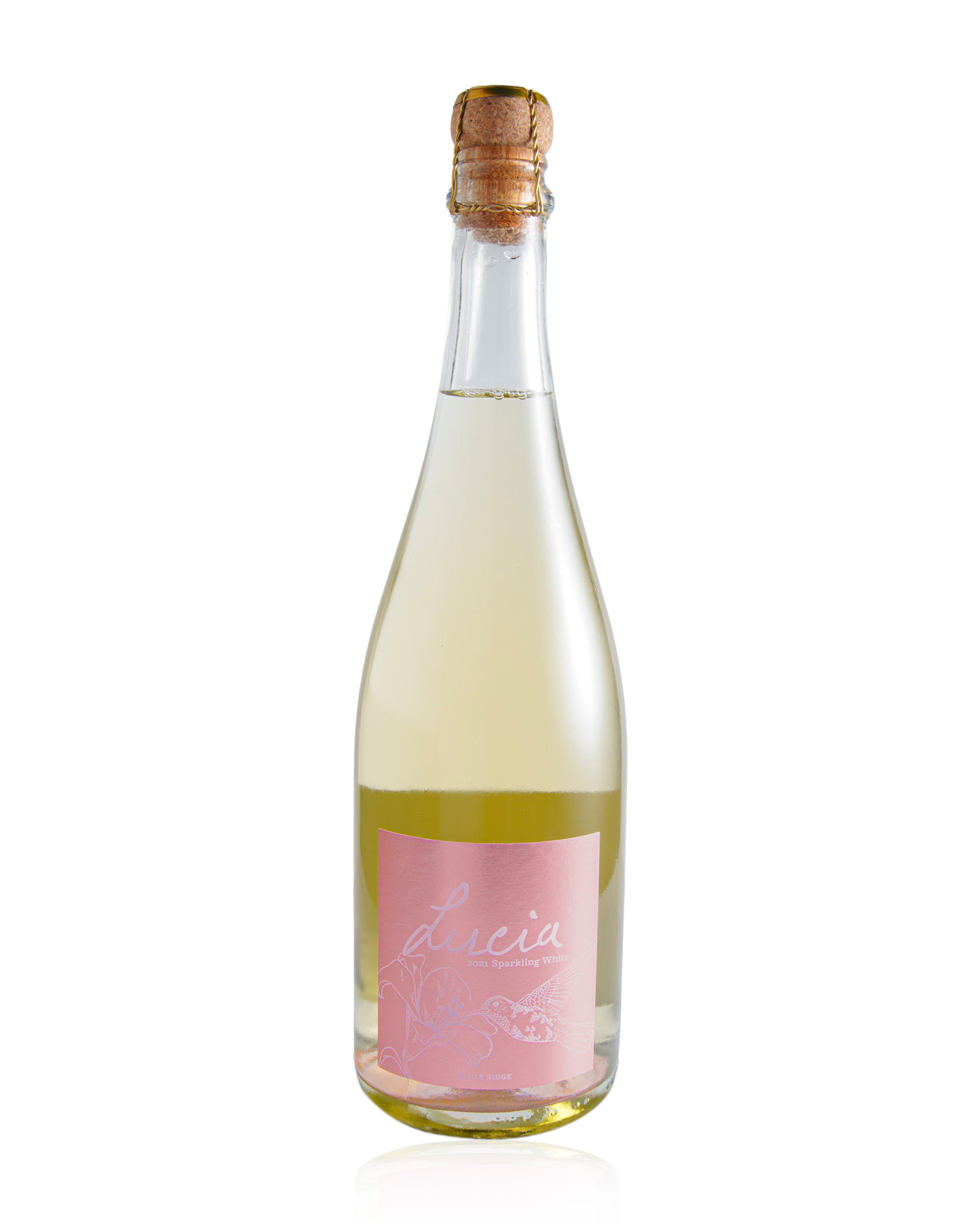 A clear glass bottle of sparkling wine with a pink label reading 'Lucia' and a cork stopper, shown on a white background with a faint reflection.