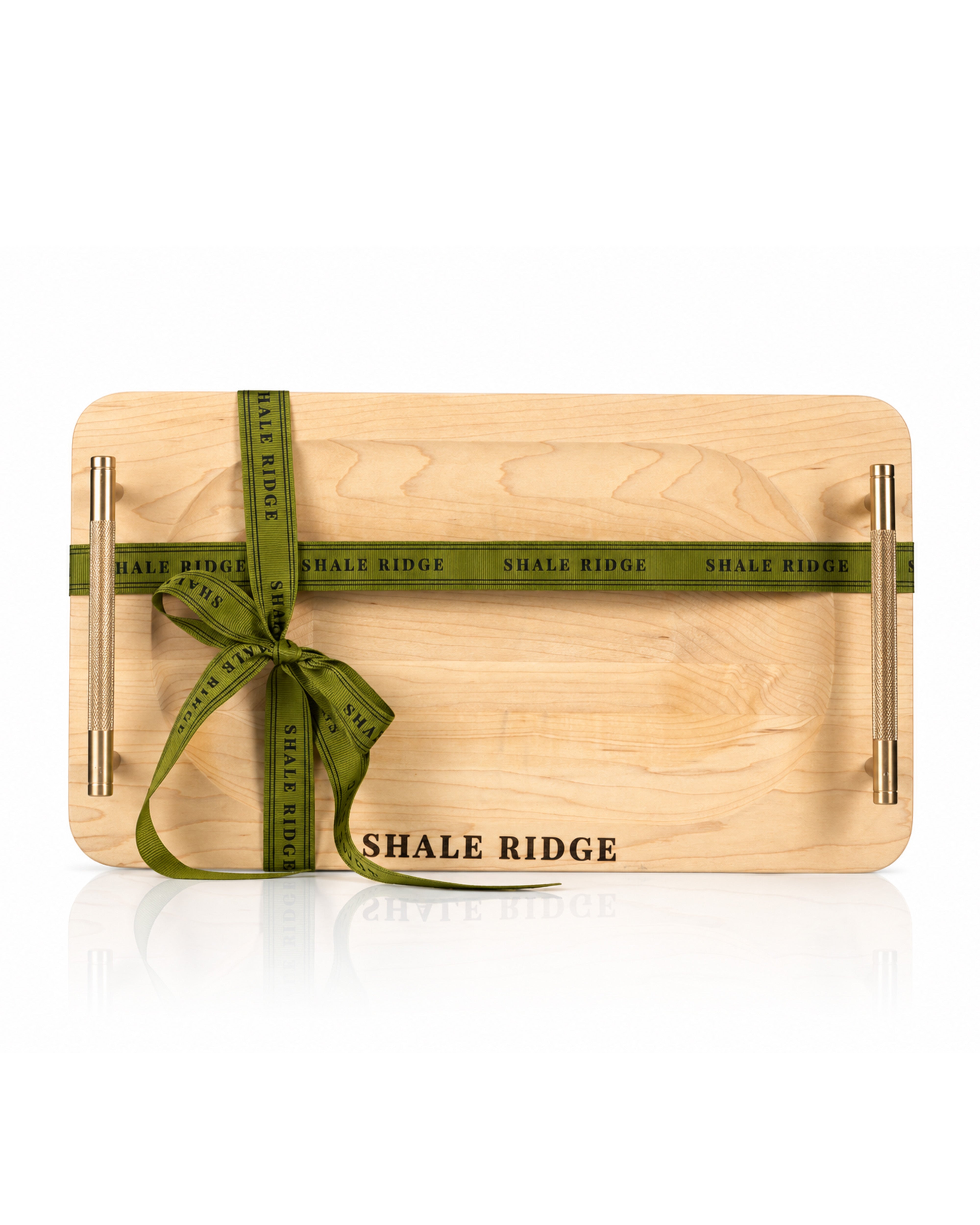 A single Shale Ridge branded charcuterie board with a green ribbon wrapped around it