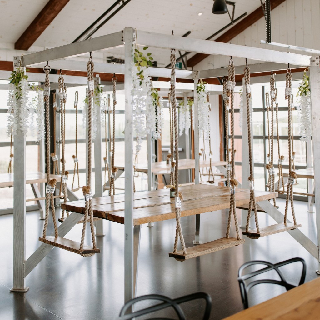 Indoor swing table dining experience at Shale Ridge Nordic Spa with rustic wood and rope seating