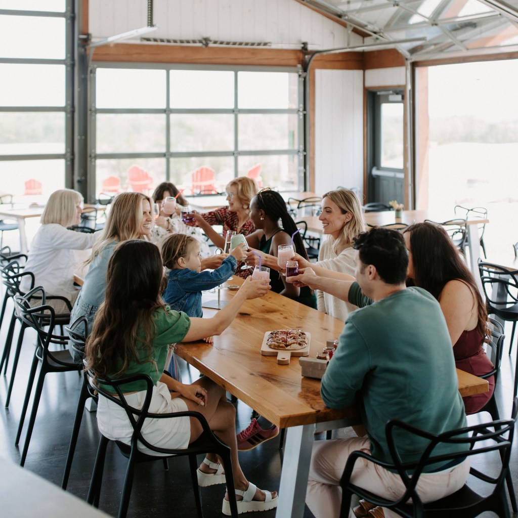Large group enjoying drinks and food together at Shale Ridge indoor dining area